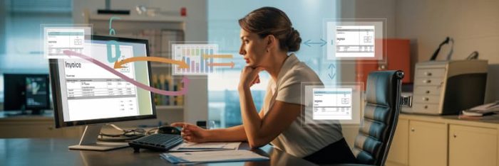 Dirigeante d’entreprise consultant les flux de factures électroniques sur son écran